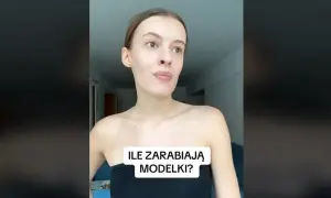 Młoda kobieta w czarnym topie zastanawia się, ile zarabia modelka w Polsce.