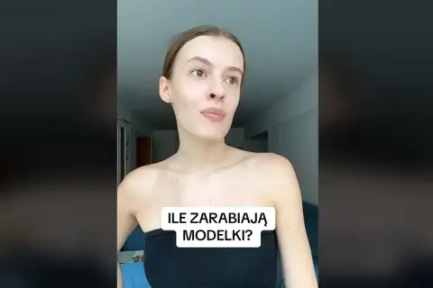 Młoda kobieta w czarnym topie zastanawia się, ile zarabia modelka w Polsce.