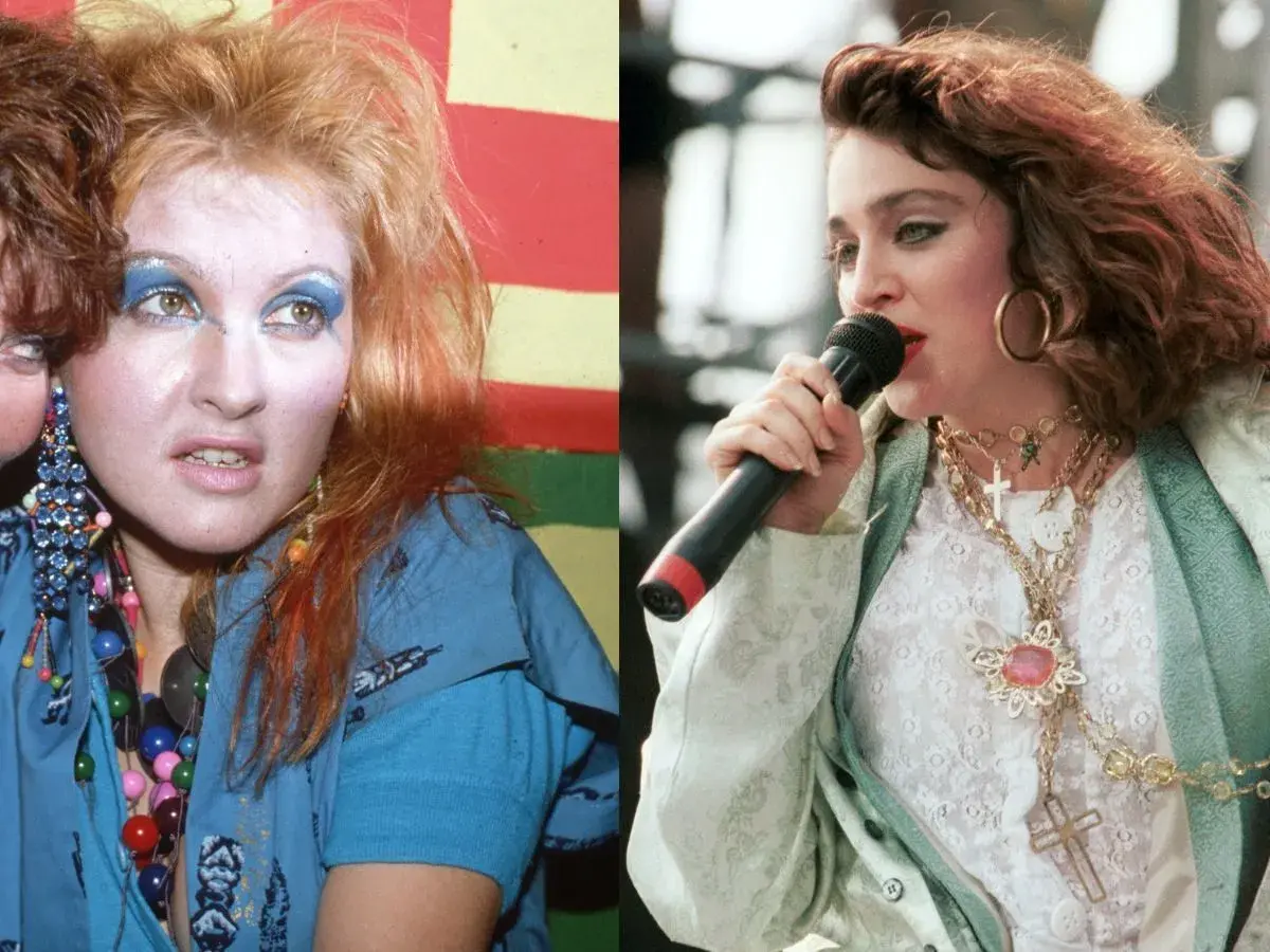 Ikony lat 80. w szalonych stylizacjach na imprezę: Cyndi Lauper z kolorowymi koralikami i Madonna z krzyżykami na szyi.