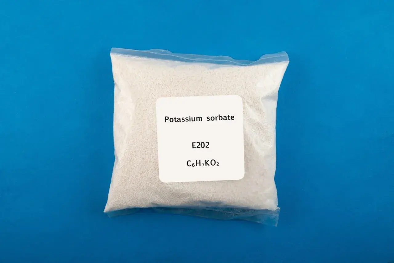 Biały proszek w przezroczystej torebce, oznaczony jako sorbinian potasu (potassium sorbate), E202, C6H7KO2.