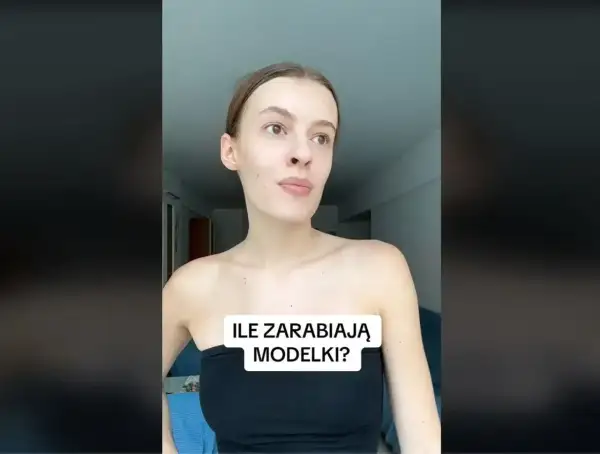 Młoda kobieta w czarnym topie zastanawia się, ile zarabia modelka w Polsce.